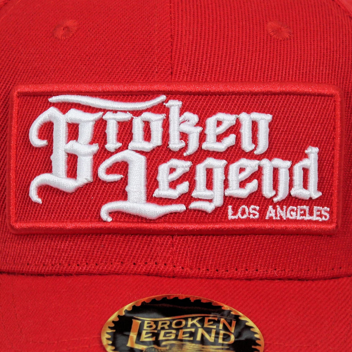 Rotes Broken Legend Cap mit seitlicher Stickerei eines fliegenden Hundes.