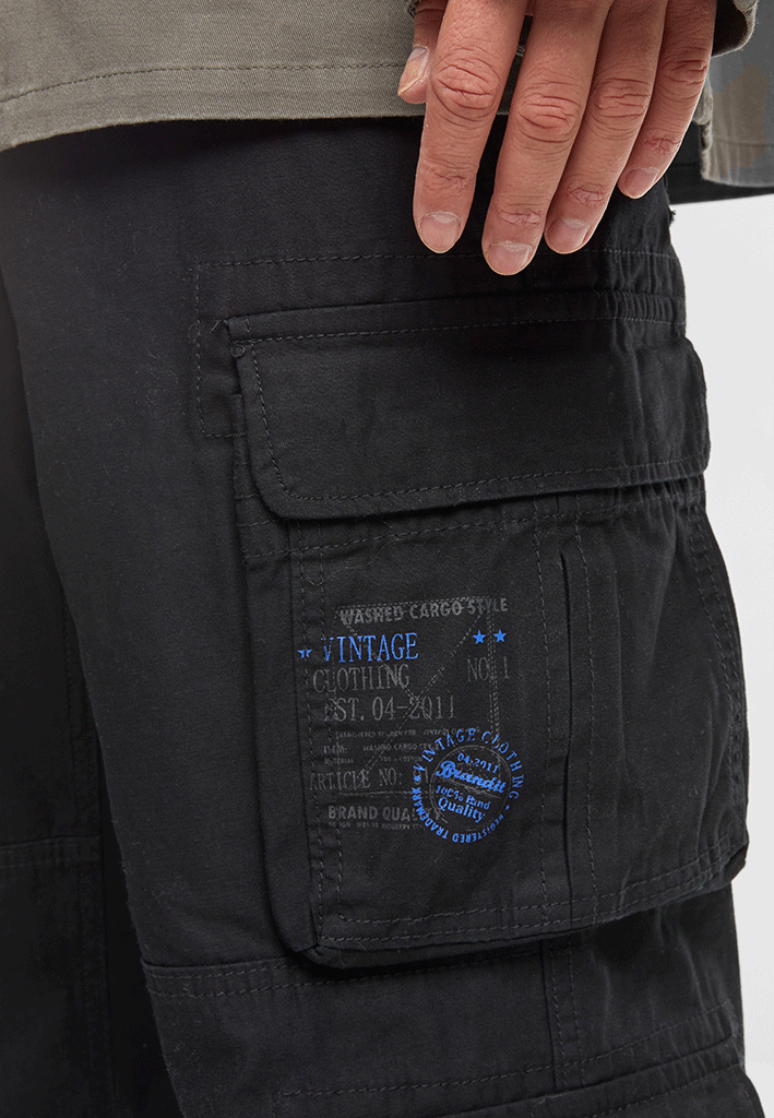 Seitenansicht der Brandit Pure Vintage Pants Schwarz mit Fokus auf die aufgesetzten Cargo-Taschen. 