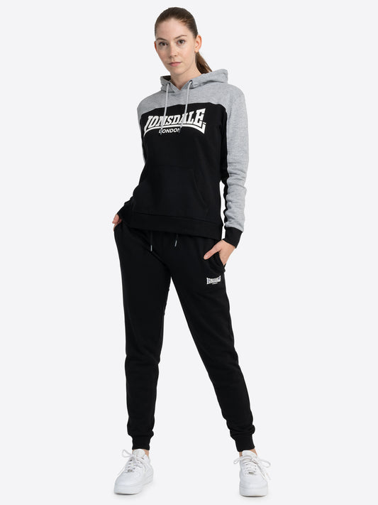 Lonsdale Frauen Trainingsanzug – Hoodie im Colour-Blocking-Design und Jogginghose mit Lonsdale-Schriftzug.