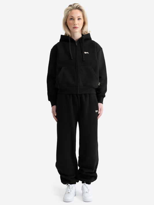 Schwarzer Lonsdale London Damen-Jogginganzug mit Kapuzenjacke, Sporthose und ecrufarbenem Loewen-Badge.