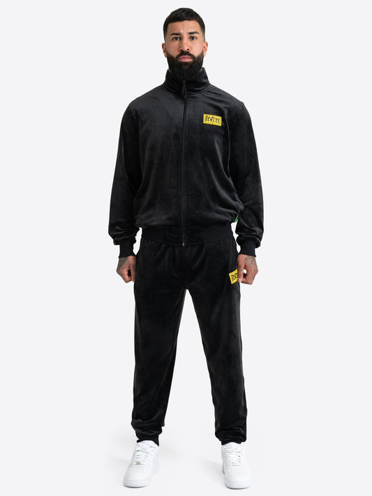 Schwarzer BENLEE Herren-Velours-Jogginganzug mit gelbem Logo-Patch auf Jacke und Hose.