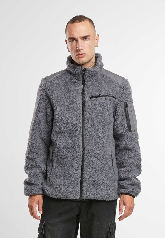 Brandit Teddyfleece Jacke in Anthra mit Ripstop-Einsaetzen, Reissverschlusstaschen, hohem Kragen und atmungsaktivem Meshfutter.
