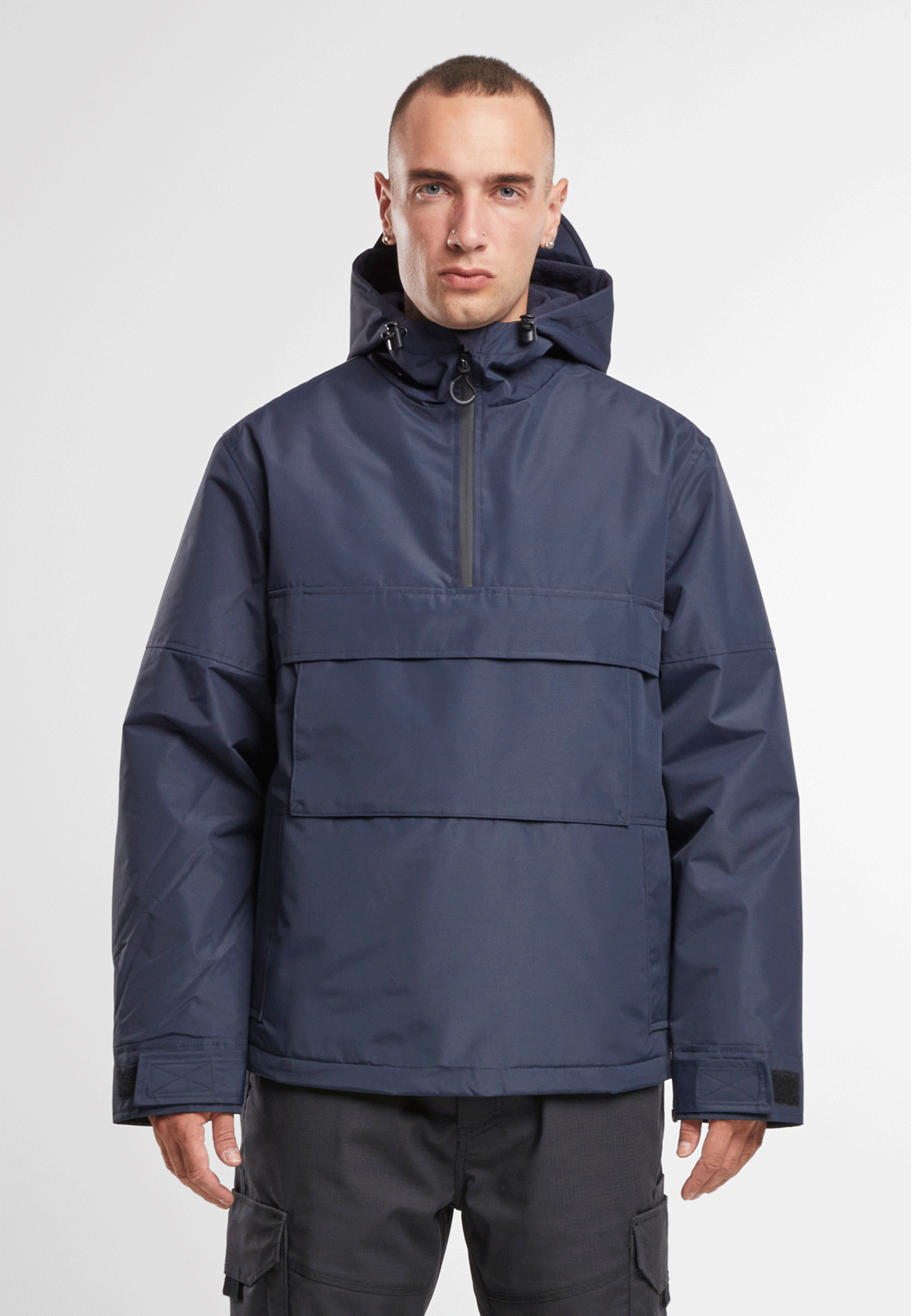 Brandit Windbreaker in Navy mit Kapuze und Regenschutz, hohem Kragen, seitlichem Reissverschluss, Fleecefutter und großer Fronttasche.