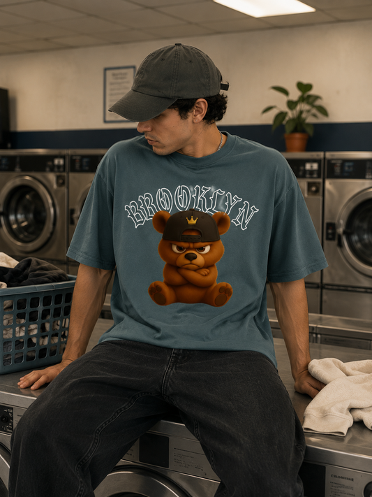 Model trägt Mister Tee Born Legend Oversize Streetwear Tee in einem urbanen Laundromat Setting