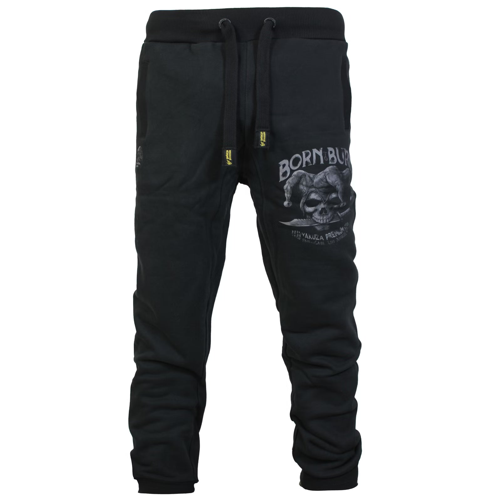 Yakuza Premium Herren Jogginghose in Schwarz Vorderansicht mit grossem Harlekin-Totenkopf Print auf dem linken Bein.